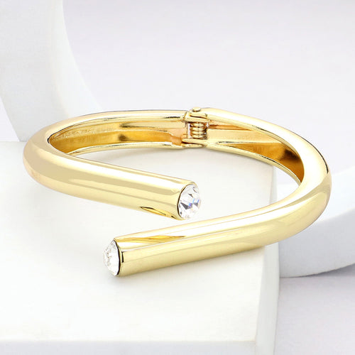 Gold bracelet with crystal accents on a white background