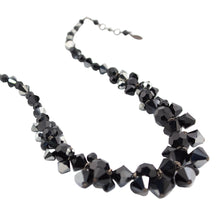 Black beaded necklace on a white background