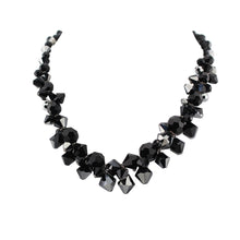 Black beaded necklace on a white background
