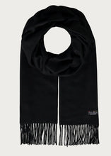 Black scarf with fringes on a light gray background