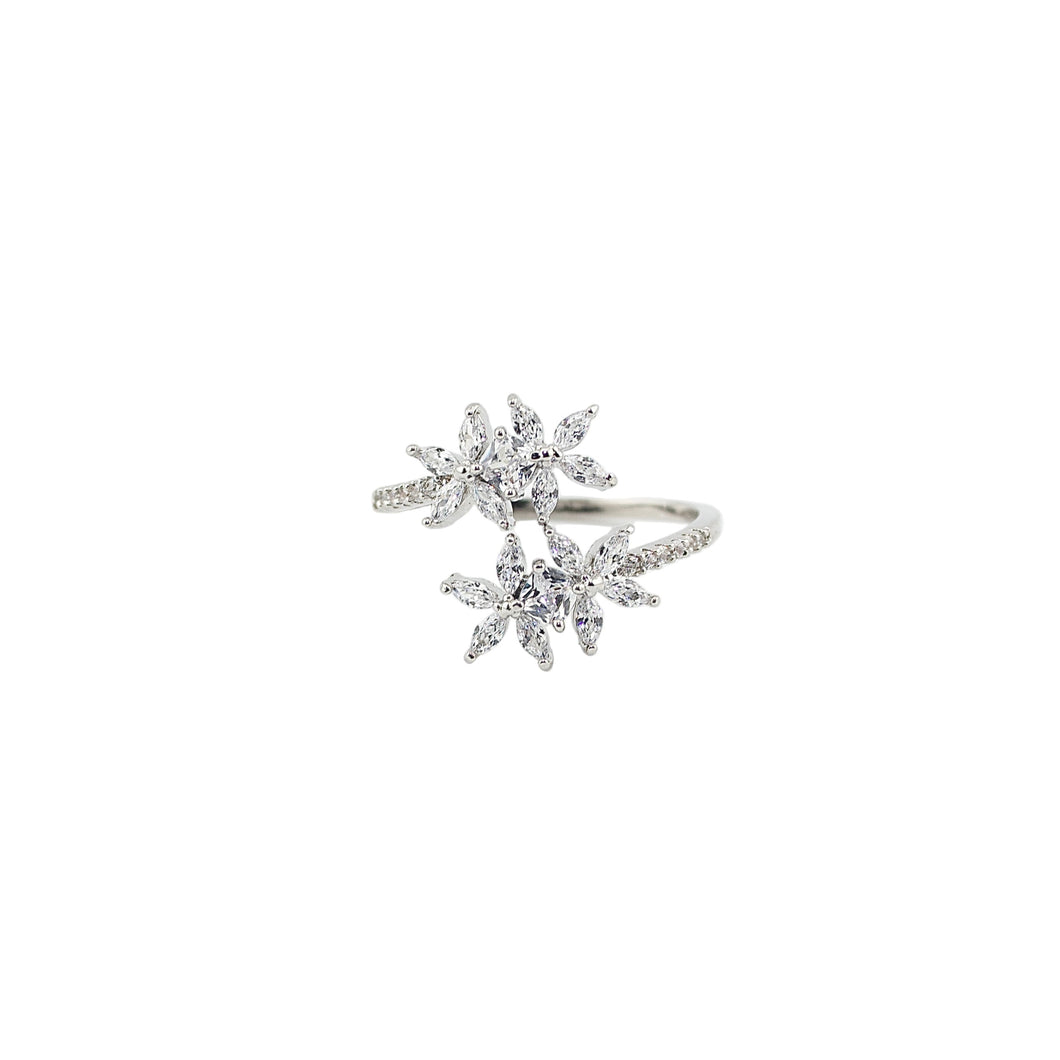 Silver ring with gemstones on a light gray background