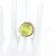 Ring with a green gemstone on a white background