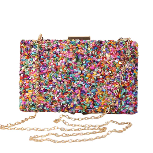 Multicolored glittery handbag with a gold chain on a white background