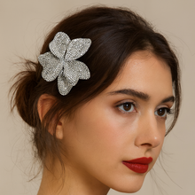 Elegant lifestyle image showcasing the CELESTIA BLOOM rhinestone pave flower hair clip styled in a model's hair against a clean background. This dual-use bridal accessory features sparkling crystal embellishments perfect for weddings, special occasions, and formal events. The photo demonstrates how this versatile piece can be worn as a statement hair clip.