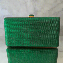 Green clutch bag on a marble surface