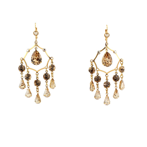 Gold chandelier earrings with brown and clear gemstones on a white background