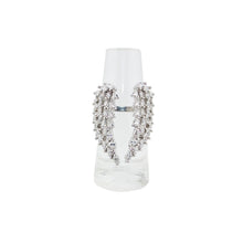 Silver earrings with clear stones on a white background