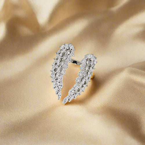 Silver earring with clear gemstones on a light gray background