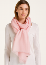 Woman wearing a pink scarf on a white background