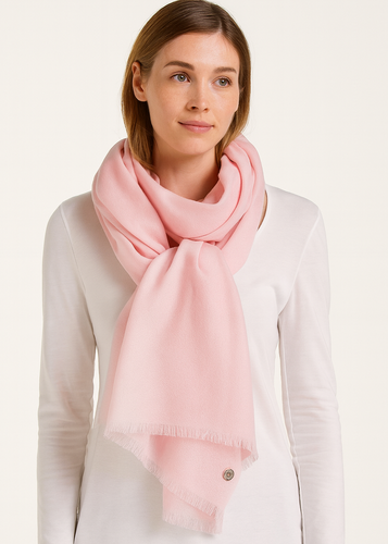 Woman wearing a pink scarf on a white background