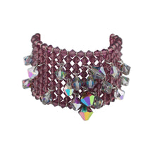 Multicolored beaded bracelet on a white pedestal