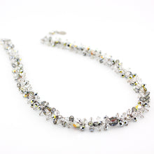 Necklace with clear and silver beads on a white background