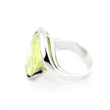 Silver ring with a green gemstone on a white background