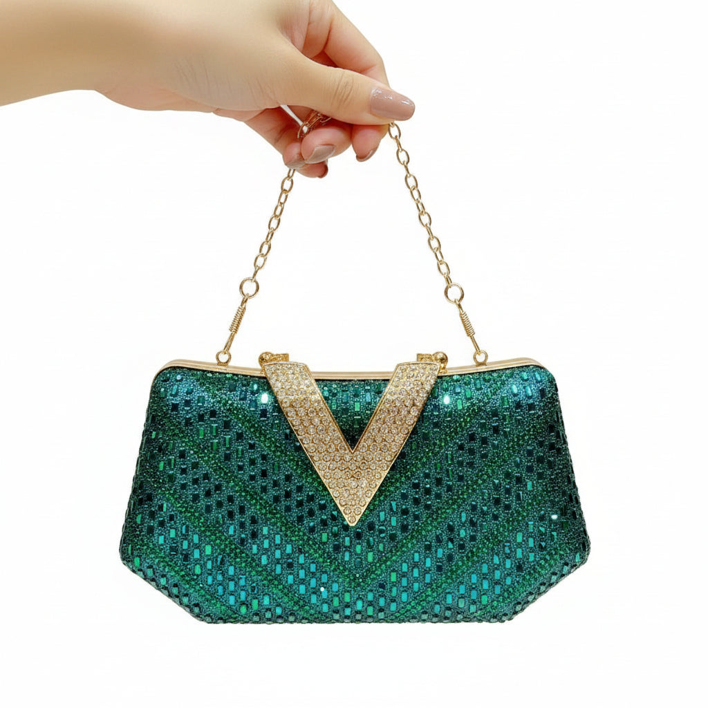 A hand holds a sparkling teal sequined clutch purse with a gold chain strap and a rhinestone-embellished V-shaped gold clasp, set against a warm beige background with vertical gold light bars.