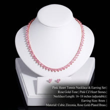 A pink cubic zirconia pave necklace displayed on a dark brown jewelry bust, with matching heart-shaped stud earrings shown in the corners. White text overlays specify the necklace length (43cm + free extension) and earring size (0.