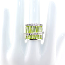 Ring with yellow green gemstone on a white background